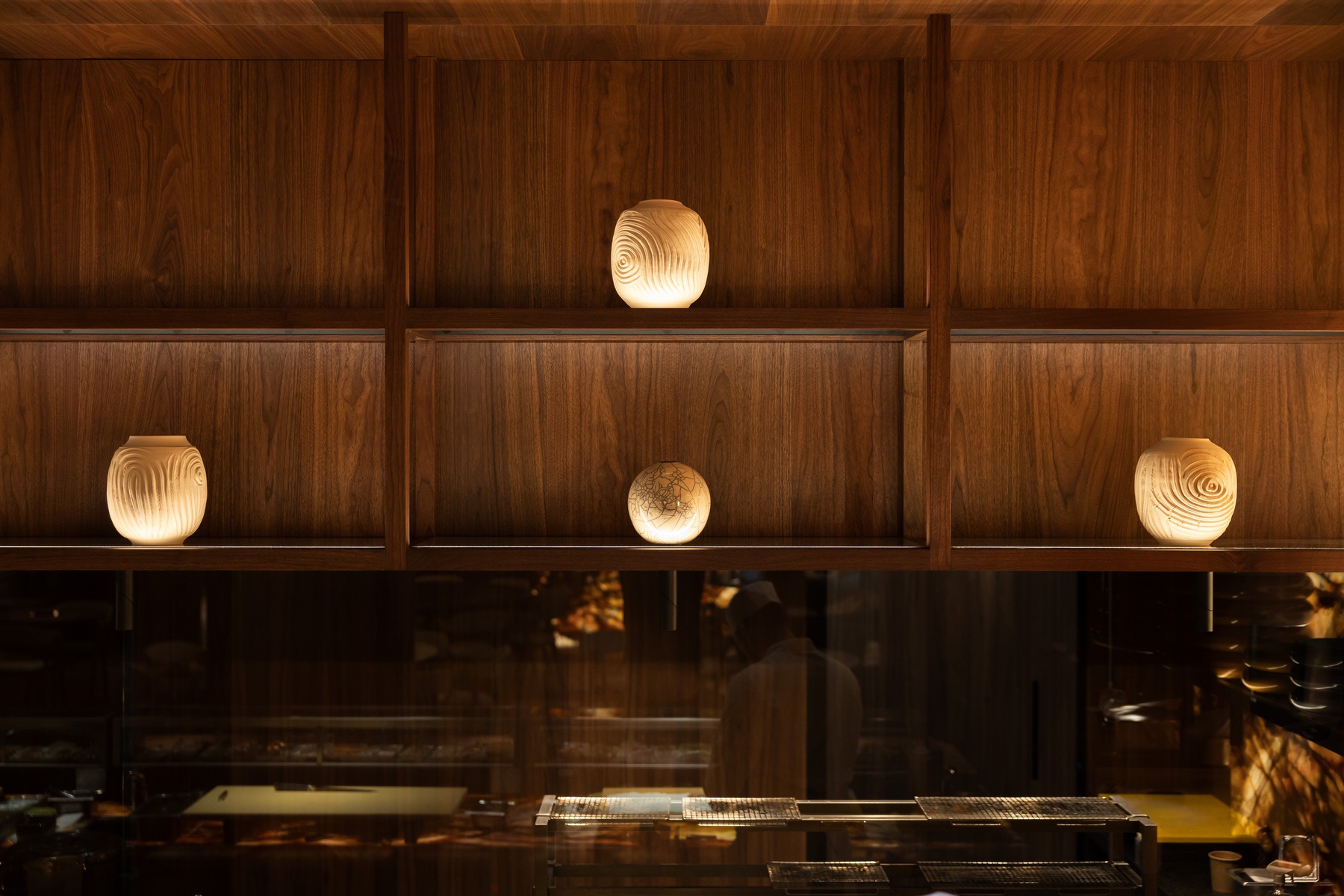Sculptural lanterns above the sushi pass